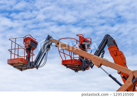 Articulate boom lift with blue sky background, Aerial platform lift telescopic boom lift hydraulic boom lift, Mobile construction crane, Construction boom lifts 129510500