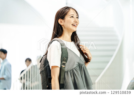 A woman going out alone with a backpack 129510839