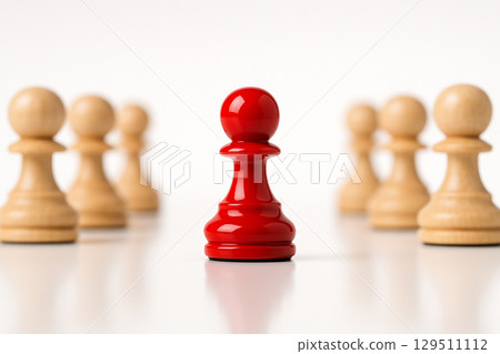 A single red figurine facing away from natural figurines symbolizing rejection, separation, or independence 129511112