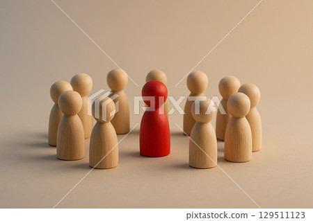 A group of natural figurines surrounding a red figurine symbolizing inclusion, support, or possible confrontation A group of natural figurines surrounding a red figurine symbolizing inclusion, support, or possible confrontation 129511123