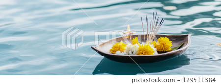 Loy Krathong festival with floating flowers and incense on water, background 129511384