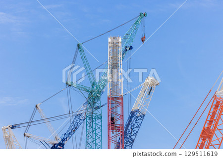 Crawler crane on blue sky white clouds background, Real estate industry. Red crawler crane use reel lift up equipment in construction site. Crane for rent. Crane dealership for construction business. 129511619