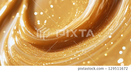 Glimmering golden swirl captures the essence of luxury and warmth in a rich, creamy texture ideal for gourmet dishes or extravagant desserts 129511672