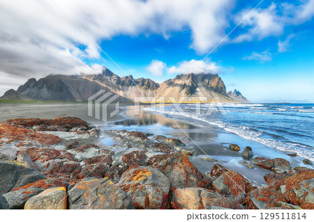 Amazing sunny day and dramatic black sand beach on Stokksnes cape in Iceland 129511814