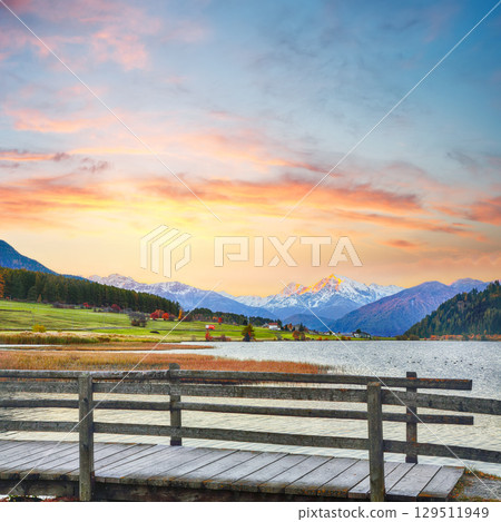 Gorgeous autumn view of Haidersee (Lago della Muta) lake with Ortler peak on background. 129511949