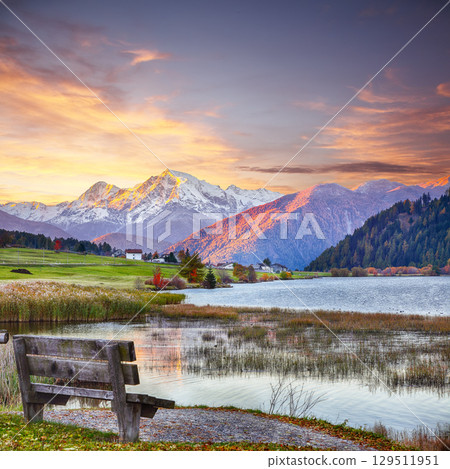 Fabulous autumn view of Haidersee (Lago della Muta) lake with Ortler peak on background. Fabulous autumn view of Haidersee (Lago della Muta) lake with Ortler peak on background. 129511951