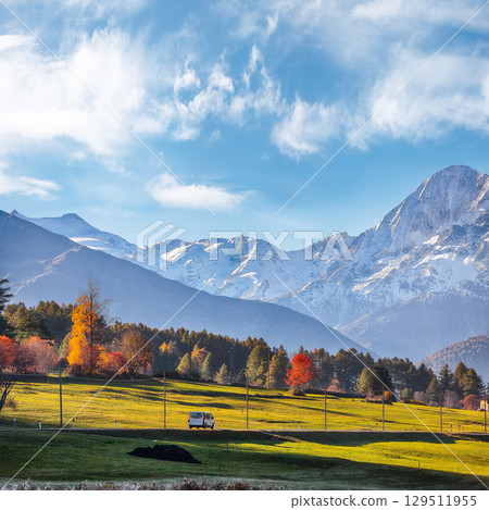 Fabulous autumn view of Haidersee (Lago della Muta) lake with Ortler peak on background. 129511955