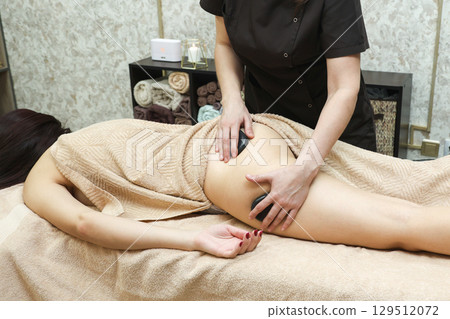 Female Massage Therapist Addressing Cellulite Issues on Women's Thighs, Legs, and Buttocks with Expertise 129512072