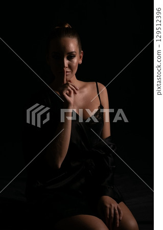 Woman Holding Finger To Her Lips For Silence 129512396
