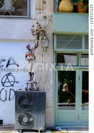 Eclectic Urban Street Art: Chandelier Sculpture & Graffiti on Weathered Wall 129513225