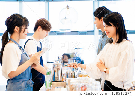 Couple paying with smartphone 129513274