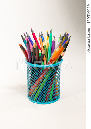 Colorful Pencils Organized in a Green Mesh Holder for Back to School Preparation 129514019