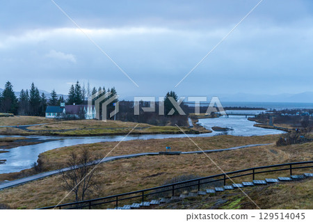 A view of the Icelandic Prime Minister's summer residence and bridge along the river A view of the Icelandic Prime Minister's summer residence and bridge along the river 129514045