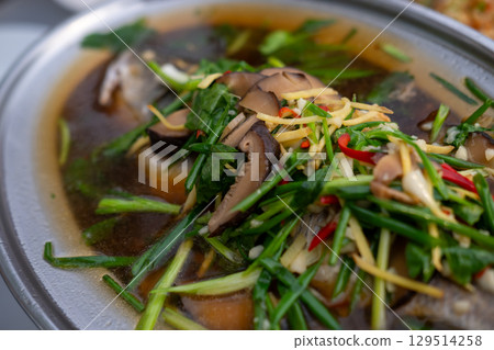 Streamed Seabass Fish with Soy Sauce served on plate. Thai food Streamed Seabass Fish with Soy Sauce served on plate. Thai food 129514258