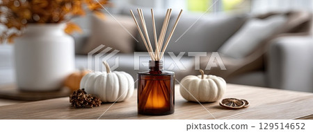 Autumn decorations create a cozy atmosphere with pumpkins, dried oranges, candles, and an inviting aromatherapy diffuser nearby Autumn decorations create a cozy atmosphere with pumpkins, dried oranges, candles, and an inviting aromatherapy diffuser nearby 129514652