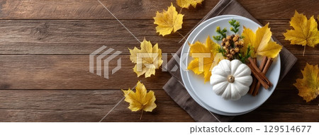 Delicate white pumpkin placed on a brown plate, complemented by a soft napkin, ideal for an autumn-themed Halloween celebration 129514677