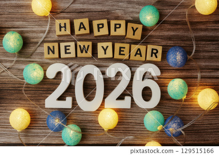 Happy New Year 2026. Wooden surface with a large number of colorful balls. Happy New Year 2026. Wooden surface with a large number of colorful balls. 129515166