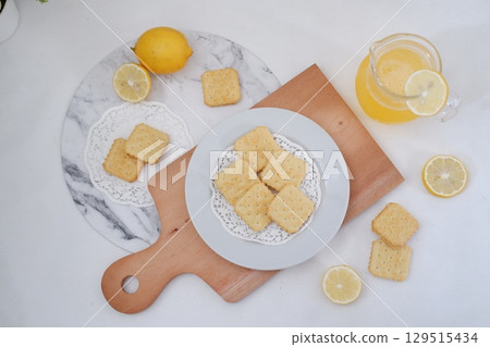 Crispy Lemon Cookies on Wooden Board 129515434