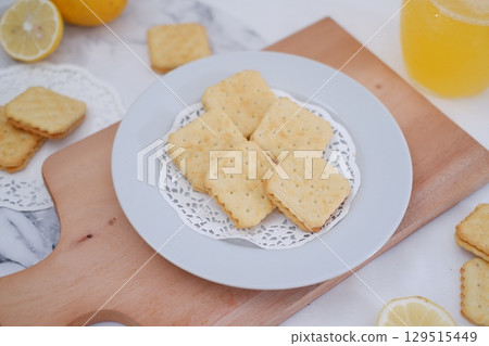 Crispy Lemon Cookies on Wooden Board 129515449
