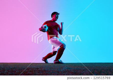 Excited soccer player celebrating win on field 129515769