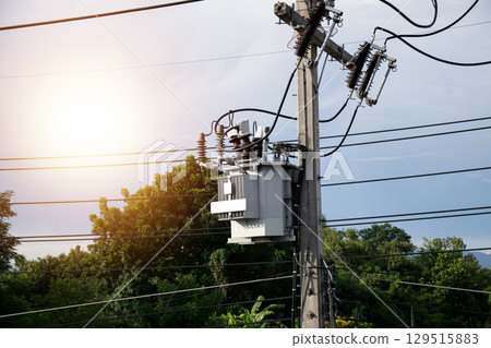 Large electric transformers installed on electric poles 129515883
