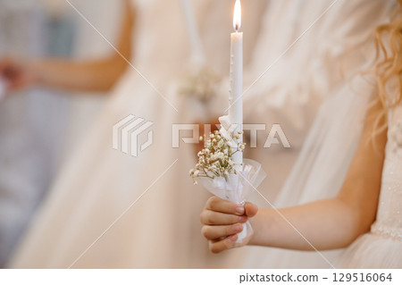 First Communion Ceremony Candle Lighting with Children, White Robes, Baby Jesus, and Floral Decoration, Soft Natural Lighting, Religious Event First Communion Ceremony Candle Lighting with Children, White Robes, Baby Jesus, and Floral Decoration, Soft Natural Lighting, Religious Event 129516064