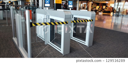 Modern airport security gate with yellow and black security barrier for passenger access control. Airport Security Gate Barrier concept 129516289