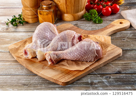 Fresh raw chicken drumstick over board Fresh raw chicken drumstick over board 129516475