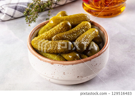 Marinated canned green cornichon cucumbers 129516483