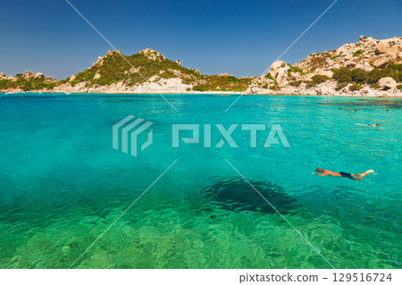 Man snorkeling in clear turquoise waters of Cala Corsara on Spargi Island in Sardinia Italy Man snorkeling in clear turquoise waters of Cala Corsara on Spargi Island in Sardinia Italy 129516724