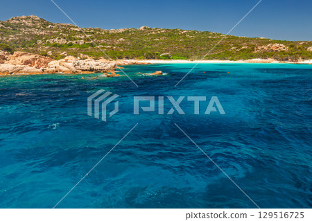 Rocky coastline and vibrant blue waters of an untouched beach on Spargi Island in Sardinia Italy 129516725