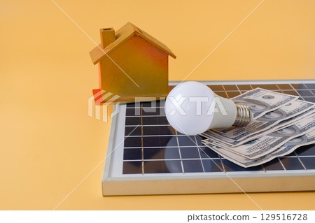 Composition with solar panel, led lamp, money and model house on texture background. Composition with solar panel, led lamp, money and model house on texture background. 129516728