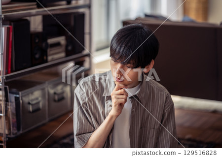 A man thinking while listening to music 129516828
