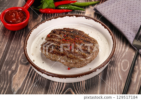 Grilled beef burger cutlet with sauce 129517184