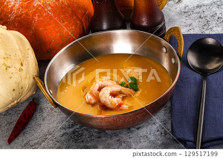 Pumpkin cream soup with prawns 129517199