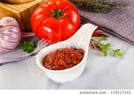 Salsa dip with chili and tomato 129517242
