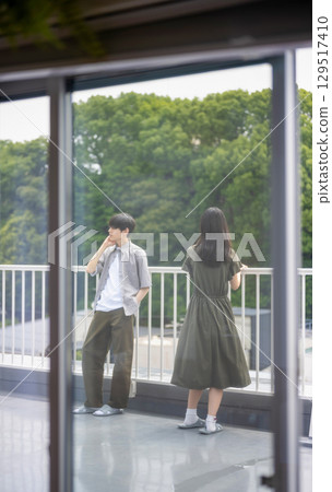 A youthful scene of a man and woman talking under the blue sky A youthful scene of a man and woman talking under the blue sky 129517410