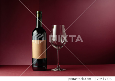 Red wine on a dark red background. 129517420