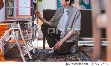 Man adjusting vintage audio equipment 129517437