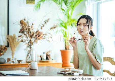 特寫鏡頭：一位微笑的女人摘下眼鏡 129517443