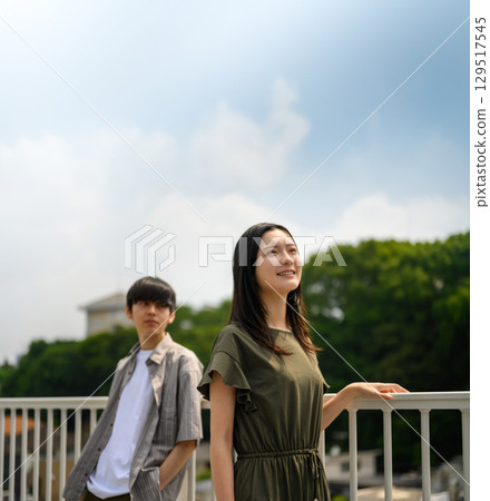 A couple under the summer sky talking about their future after school 129517545