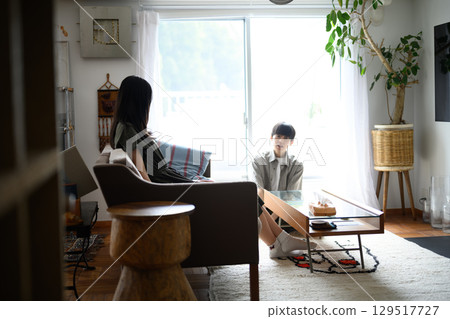 A man and a woman spending quiet time in the living room in the afternoon A man and a woman spending quiet time in the living room in the afternoon 129517727