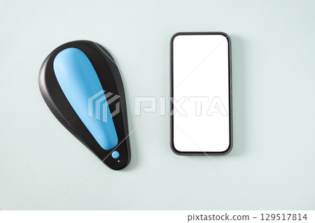 Mens kegel smart trainer and smartphone with empty white blank screen for own apps on beige background. Smart trainer for squeeze pelvic floor muscles with biofeedback and vibration. Modern technology Mens kegel smart trainer and smartphone with empty white blank screen for own apps on beige background. Smart trainer for squeeze pelvic floor muscles with biofeedback and vibration. Modern technology 129517814
