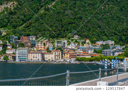 Como city on mountain. Old houses building architecture on lake Como, Italy. 129517847