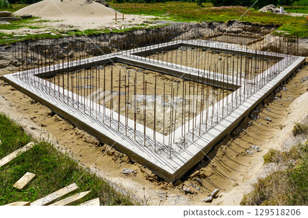 Concrete Foundation with Steel Rebar Framework at Early Stage of Building Construction Concrete Foundation with Steel Rebar Framework at Early Stage of Building Construction 129518206