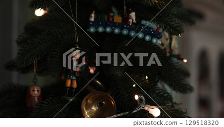 Vintage nutcracker and Santa train Christmas ornaments on Christmas tree 129518320