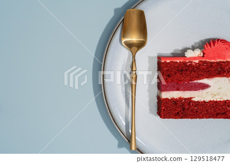 Red velvet bento cake slice on a textured plate with a golden spoon, showcasing layers of cream and vibrant colors, perfect for dessert and pastry menu concepts Red velvet bento cake slice on a textured plate with a golden spoon, showcasing layers of cream and vibrant colors, perfect for dessert and pastry menu concepts 129518477