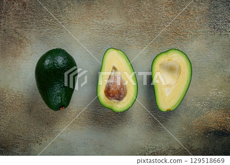 fresh sliced avocado on the table, top view, food background, concept, menu, food styling 129518669