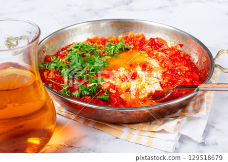 traditional Turkish dish, scrambled eggs with tomatoes, Menemen, with herbs, in a frying pan, close-up, no people, 129518679