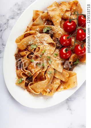 pappardelle pasta with bolognese sauce, topped with parmesan cheese and cherry branch, homemade, no people, 129518718